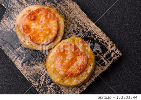 Round fish or chicken cutlets baked with tomato and cheese. Fish cutlets Round fish or chicken cutlets baked with tomato and cheese. Fish cutlets 133503544