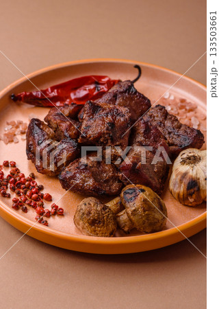 Beef, grilled meat in pieces, or kebab with sauce and vegetables. Beef in pieces Beef, grilled meat in pieces, or kebab with sauce and vegetables. Beef in pieces 133503661