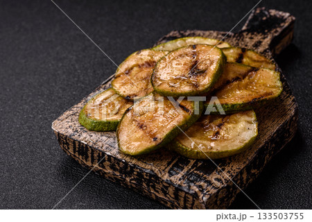 Grilled green zucchini slices, vegetarian food. Green barbecue zucchini Grilled green zucchini slices, vegetarian food. Green barbecue zucchini 133503755