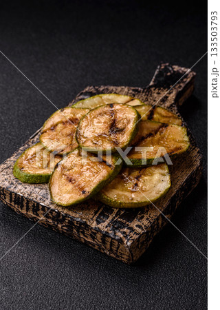 Grilled green zucchini slices, vegetarian food. Green barbecue zucchini Grilled green zucchini slices, vegetarian food. Green barbecue zucchini 133503793