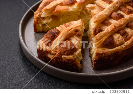 Sweet American pie with apples, pears, and cinnamon, a homemade dessert. Apple American pie Sweet American pie with apples, pears, and cinnamon, a homemade dessert. Apple American pie 133503911