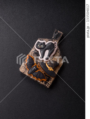 Halloween cookies, sweets, or gingerbread, a cat, a bat, and a hat. Halloween gingerbread 133504017