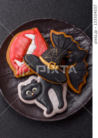 Halloween cookies, sweets, or gingerbread, a cat, a bat, and a hat. Halloween gingerbread 133504037
