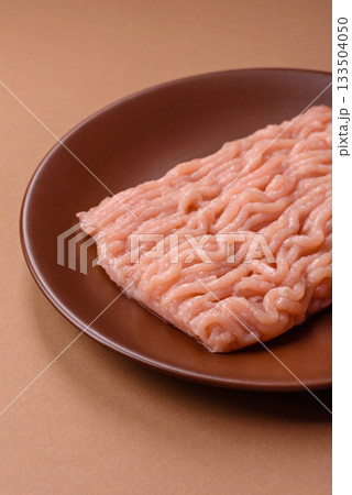 Raw minced chicken for a burger or as an ingredient in a meat dish. Raw ground chicken Raw minced chicken for a burger or as an ingredient in a meat dish. Raw ground chicken 133504050