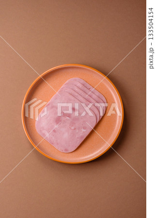 Meat, square ham sliced, organic food, protein for snacks. Sliced ham as a background Meat, square ham sliced, organic food, protein for snacks. Sliced ham as a background 133504154