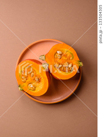 Half a raw pumpkin, a ripe orange colored butternut squash. Raw pumpkin Half a raw pumpkin, a ripe orange colored butternut squash. Raw pumpkin 133504305