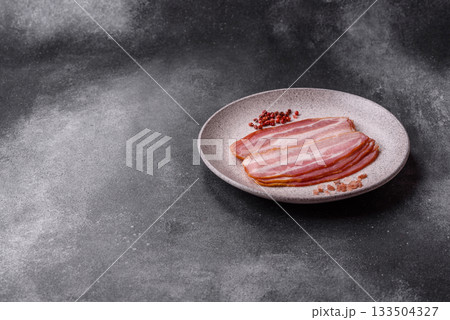 Meat, raw pork bacon sliced, organic food, protein for snacks. Raw bacon as a background Meat, raw pork bacon sliced, organic food, protein for snacks. Raw bacon as a background 133504327