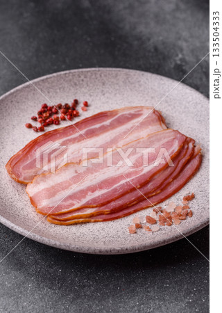 Meat, raw pork bacon sliced, organic food, protein for snacks. Raw bacon as a background Meat, raw pork bacon sliced, organic food, protein for snacks. Raw bacon as a background 133504333