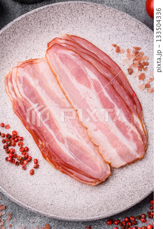 Meat, raw pork bacon sliced, organic food, protein for snacks. Raw bacon as a background Meat, raw pork bacon sliced, organic food, protein for snacks. Raw bacon as a background 133504336