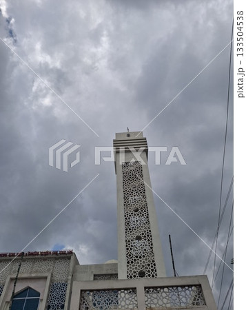 Elegant Mosque Exterior Under a Cloudy Sky with Intricate Architectural Details Elegant Mosque Exterior Under a Cloudy Sky with Intricate Architectural Details 133504538