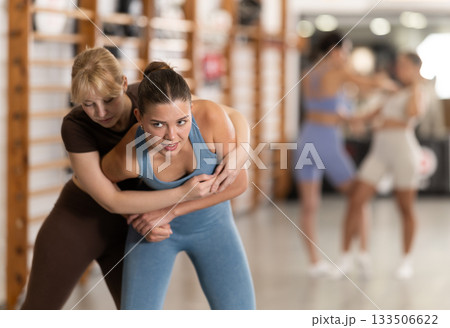 Young women in self-defense training Young women in self-defense training 133506622