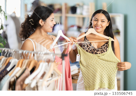 Two Latinas choose summer clothes together 133506745