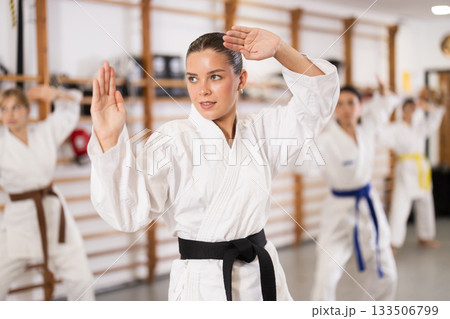 Young women during group karate training Young women during group karate training 133506799