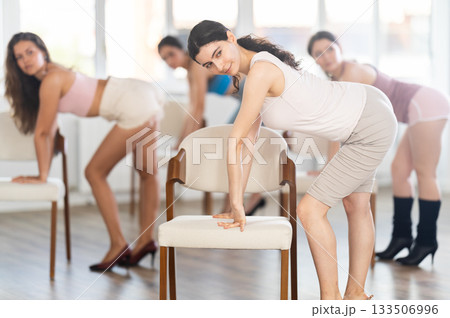 Beautiful graceful chair dance class practice at wall and window hall 133506996