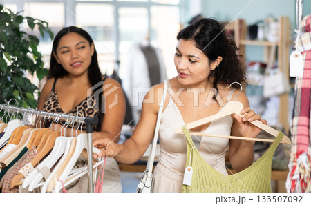 Two Latinas choose summer clothes together 133507092