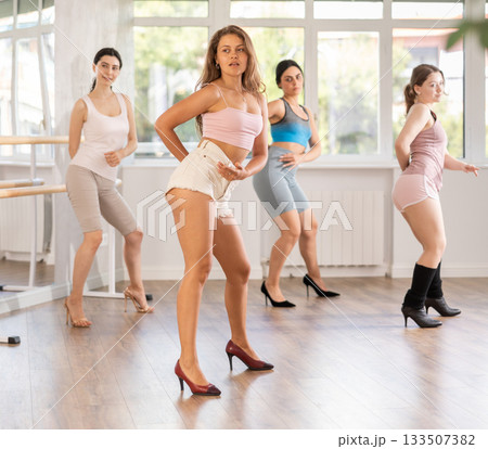 Young woman performing sass dance at group class Young woman performing sass dance at group class 133507382
