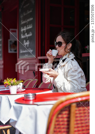 Woman drinking coffee at Paris street cafe Woman drinking coffee at Paris street cafe 133507806