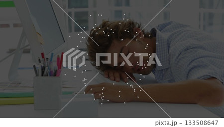 Leaning forward office worker dozing on arms at office desk, with monitor and folders, copy space 133508647