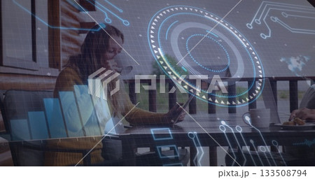 Woman and man collaborating at wooden balcony table on tablet and laptop, with AR graphics Woman and man collaborating at wooden balcony table on tablet and laptop, with AR graphics 133508794