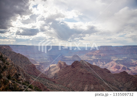 Atmospheric Grand Canyon View with Sunlight Breaking Through Clouds 133509732