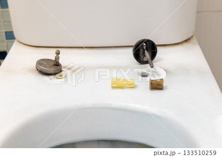 Old toilet seat rubber bungs is broken. Bathroom toilet seat replacement concept. Old toilet seat rubber bungs is broken. Bathroom toilet seat replacement concept. 133510259