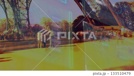 Walking tourists carrying backpacks at Eiffel Tower under lattice pillars, with neon AR overlay 133510479