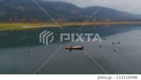 Lone paddler wearing knit cap and life vest paddling across lake, with digital measurement overlays Lone paddler wearing knit cap and life vest paddling across lake, with digital measurement overlays 133510496