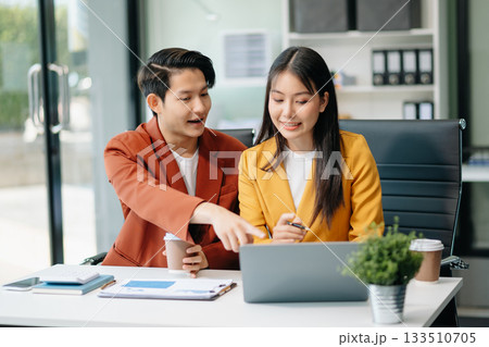 Businesswomen work and discuss their business plans. A Human employee explains and shows her colleague the results paper Businesswomen work and discuss their business plans. A Human employee explains and shows her colleague the results paper 133510705