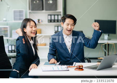 Asian business team and lawyers discussing contract papers sitting at the table. Concepts of law, advice, legal services. Asian business team and lawyers discussing contract papers sitting at the table. Concepts of law, advice, legal services. 133511070