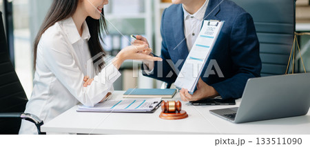 Judge gavel with scales of justice, Business and lawyer or counselor consulting and discussing contract papers with laptop 133511090