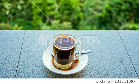 close-up photo of a glass of coffee with milk close-up photo of a glass of coffee with milk 133511097