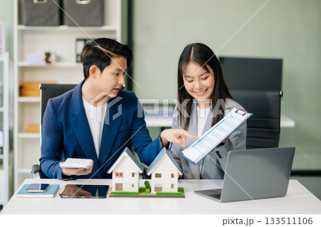 Real estate broker agent presenting and consult to customer to decision making sign insurance form agreement, home model, 133511106