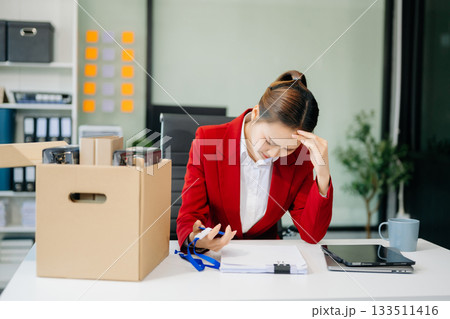 young beautiful Asian woman office worker celebrating her resignation, carrying her personal stuff. leaving job, changing or company 133511416