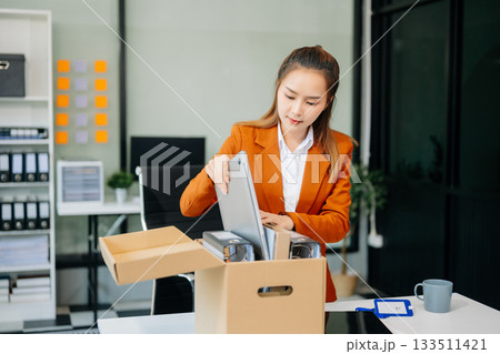 young beautiful Asian woman office worker celebrating her resignation, carrying her personal stuff. leaving job, changing or company young beautiful Asian woman office worker celebrating her resignation, carrying her personal stuff. leaving job, changing or company 133511421