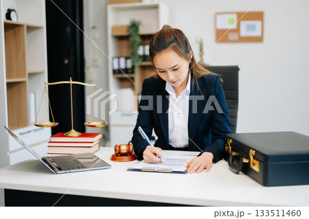 Asian lawyer woman working with a laptop and tablet in a law office. Legal and legal service concept. 133511460