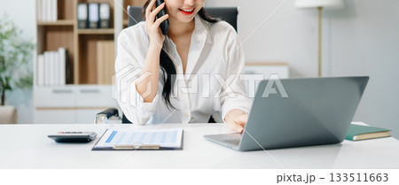 businesswoman working at office with laptop, tablet and taking notes on the paper. 133511663