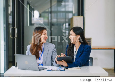 Asian business colleague business presents and explains and using laptop and tablet. Teamwork, financial marketing team, Asian business colleague business presents and explains and using laptop and tablet. Teamwork, financial marketing team, 133511798