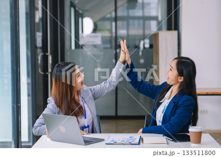 Asian business colleague business presents and explains and using laptop and tablet. Teamwork, financial marketing team, Asian business colleague business presents and explains and using laptop and tablet. Teamwork, financial marketing team, 133511800