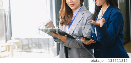 Asian business colleague business presents and explains and using laptop and tablet. Teamwork, financial marketing team, Asian business colleague business presents and explains and using laptop and tablet. Teamwork, financial marketing team, 133511813
