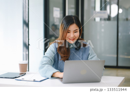 Woman freelancer is working her job on computer tablet and laptop Doing accounting analysis report real estate investment data, Financial Woman freelancer is working her job on computer tablet and laptop Doing accounting analysis report real estate investment data, Financial 133511944