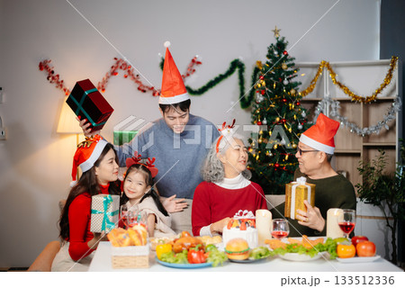 Joyful Asian family celebrating Christmas together with gifts, festive food, and decorations, capturing love, Joyful Asian family celebrating Christmas together with gifts, festive food, and decorations, capturing love, 133512336
