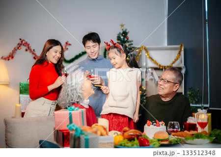 Celebrate Christmas with family in a cozy, festive setting filled with gifts, love, and joy. Celebrate Christmas with family in a cozy, festive setting filled with gifts, love, and joy. 133512348