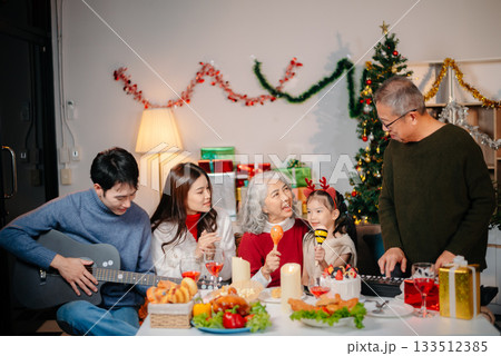 Celebrate Christmas with family in a cozy, festive setting filled with gifts, love, and joy. 133512385