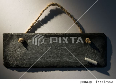 Hanging chalkboard on dark background Hanging chalkboard on dark background 133512908