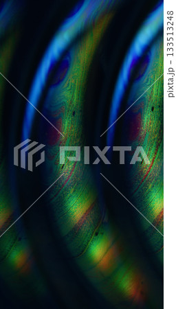 Defocused gasoline acid. Light liquid. Green blue orange colorful ink curve pigment acrylic neon bubble floating on abstract art background. 133513248