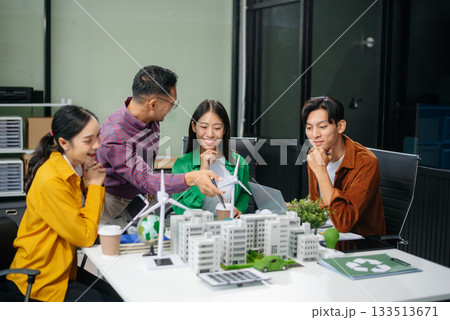 Group of diverse multiethnic businesspeople standing neare table looking at model of building from residential project. 133513671