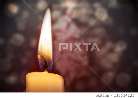 Candle burning against festive background 133514123