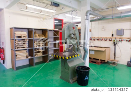 Industrial band saw machine is being shown in flat design workshop, with wooden shelving and hoses Industrial band saw machine is being shown in flat design workshop, with wooden shelving and hoses 133514327