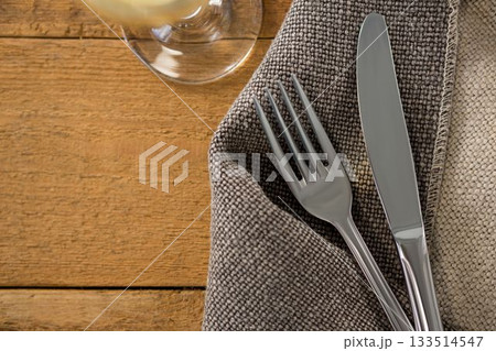 Fork and knife on sack at wooden table Fork and knife on sack at wooden table 133514547