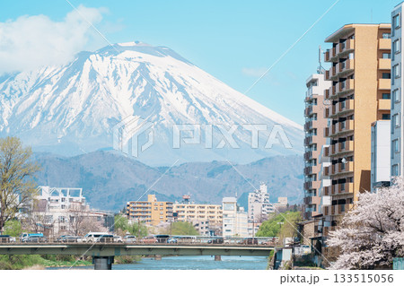 Beautiful Iwate mountain and Kitakami river with flowers blooming in Spring season, cityscape against blue sky in Morioka city, Iwate prefecture, Japan. famous Landmark Travel and Vacation destination Beautiful Iwate mountain and Kitakami river with flowers blooming in Spring season, cityscape against blue sky in Morioka city, Iwate prefecture, Japan. famous Landmark Travel and Vacation destination 133515056